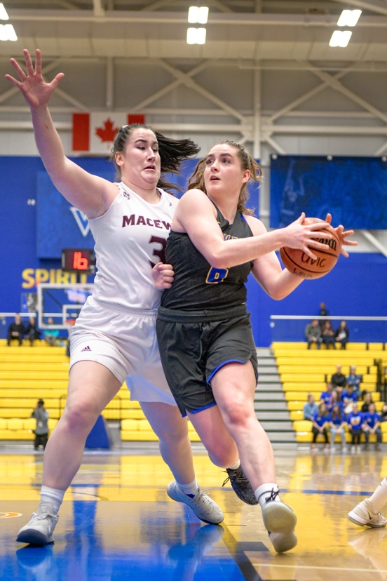 Uvic's Haily Weaver (6) head in for a shot with Griffin's Ellie